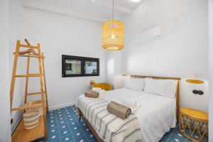 a bedroom with a white bed with a ladder and a ladderweredwered at Vista Azul by Vintage Travel in Loulé +41 photos