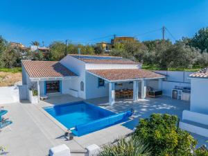 a swimming pool in the backyard of a house at Vista Azul by Vintage Travel in Loulé
