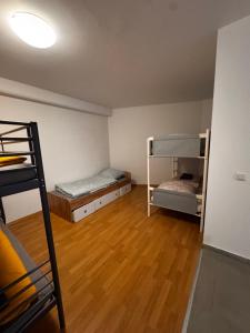 a room with two bunk beds and a wooden floor at Bay Fewo in Rosenheim