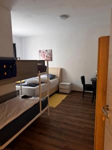 a room with two bunk beds and a desk at Bay Fewo in Rosenheim