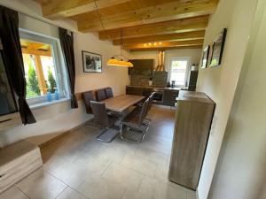 a dining room with a table and some chairs at Villa Sonnenblick in Kötschach