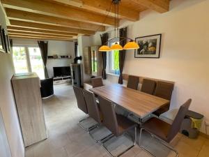 a dining room with a wooden table and chairs at Villa Sonnenblick in Kötschach +13 photos