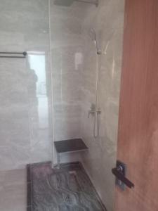 a bathroom with a shower with a bench in it at Luxor lights palace in Luxor