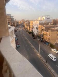 a view of a city street from a balcony at Luxor lights palace in Luxor