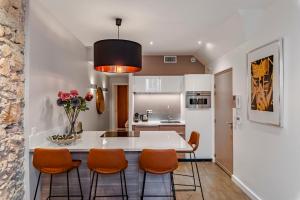 a kitchen with a white table and orange chairs at Totolulu Cannes Luxury Properties in Cannes +131 photos