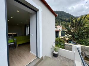 a balcony with a view of a house at Maria s Guest House, By OP in Ponta Delgada