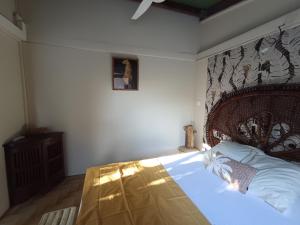 a bedroom with a large bed with a wooden headboard at Ma chambre Javanaise in Port-Louis +21 photos