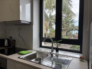 a kitchen with a sink and a window at Maria s Guest House, By OP in Ponta Delgada