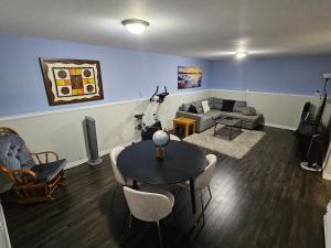 a living room with a table and a couch at Modern Comfort Haven Near Reversing Falls Bridge Saint John NB in Saint John