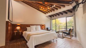 a bedroom with a large bed and a balcony at Orgánico Hotel Boutique VALLE DE BRAVO in Valle de Bravo +74 photos