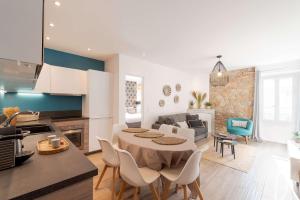 a kitchen and living room with a table and chairs at Totolulu Cannes Luxury Properties in Cannes