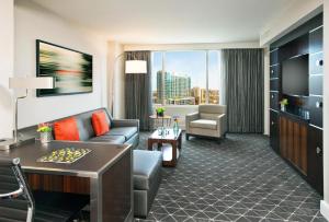 a living room with a couch and a table at Hilton Nashville Downtown in Nashville