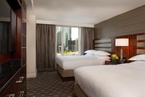 a hotel room with two beds and a window at Hilton Nashville Downtown in Nashville +47 photos