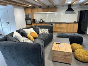 a living room with two couches and a table at Nessa Chalet in Moara de Pădure