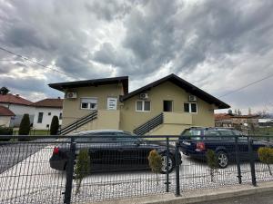 a black car parked in front of a house at Apartments Aventra in Visoko