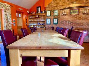 a large wooden table in a room with chairs at Willow Tree Cottages in Newark-on-Trent +19 photos