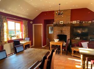 a dining room with a table and a fireplace at Willow Tree Cottages in Newark-on-Trent