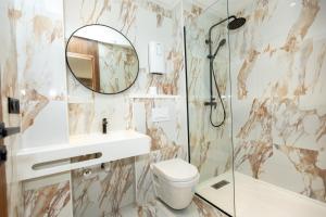a bathroom with a sink toilet and a mirror at Elite Home in Maarif +11 photos