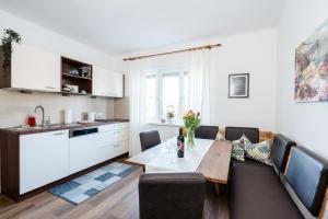 a kitchen and a dining room with a table and chairs at Pension Kohlweg - Free Parking, Garden and air conditioning in Graz