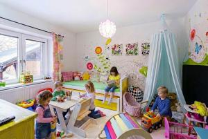a group of children sitting in a room at Apartmán Malý princ in Dolní Lomná