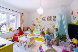 a group of children playing in a room at Apartmán Malý princ in Dolní Lomná