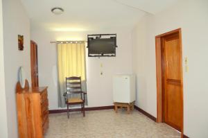 un soggiorno con frigorifero e sedia di The Log Cab-Inn a San Ignacio