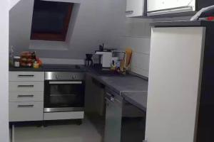 a kitchen with a stove and a counter top at Dachgeschosswohnung in historischem Monument in Görlitz