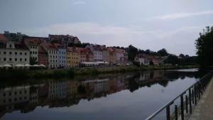 a view of a river with houses and a city at Dachgeschosswohnung in historischem Monument in Görlitz