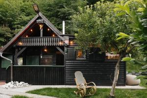 a house with a bench in front of it at Hishka Ishka Love in Iška