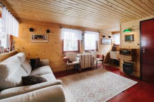 a living room with a couch and chairs in a room at Hishka Ishka Love in Iška