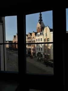a view of a building from a window at Pokoje Stary Rynek in Elblag