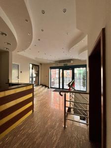 an empty room with a hallway with a staircase and windows at Pokoje Stary Rynek in Elblag