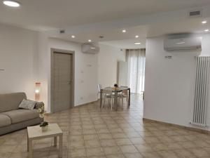 a living room with a couch and a table at Oasi del Sole in Cupra Marittima