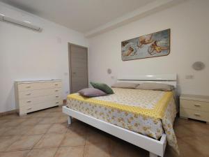 a bedroom with a bed and a dresser at Oasi del Sole in Cupra Marittima