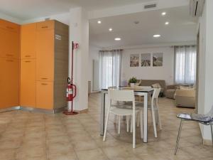 a dining room and living room with a table and chairs at Oasi del Sole in Cupra Marittima