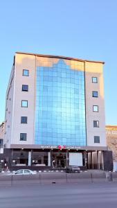 a large building with a lot of glass windows at اجنحة الطائف للشقق المخدومة - AL Taif Suites in Taif