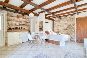 a bedroom with a bed and a table and chairs at Best view! Rooftop with Garden - Old Town Nr404 in Kotor +35 photos