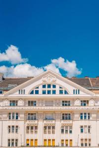 a large white building with a blue sky in the background at Loft City View in Budapest