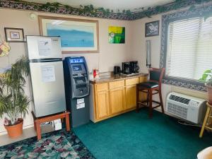 a kitchen with a refrigerator and a counter with a table at Gateway Inn in Sullivan