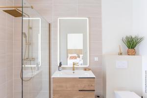 a bathroom with a sink and a mirror at Villa Andrea in Case-Pilote +3 photos