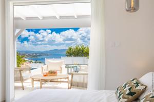 a bedroom with a view of the ocean at Villa Andrea in Case-Pilote