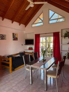 a dining room with a table and a couch at AltoRojo in Villa Elisa