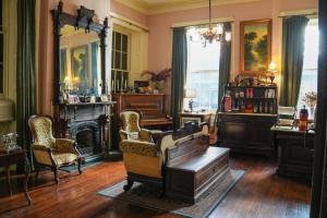 a living room with chairs and a fireplace at The Olivier House Hotel in New Orleans