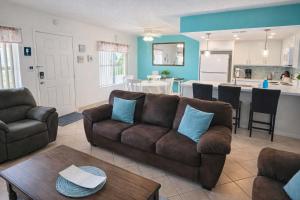 a living room with a couch and a kitchen at Fiesta Sol #110 home in South Padre Island