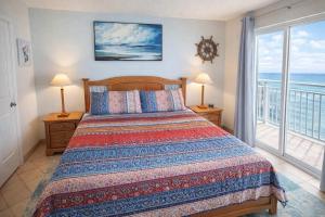 a bedroom with a bed with a view of the ocean at Fiesta Sol #110 home in South Padre Island