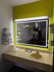 a bathroom with a sink and a mirror at Gateway Inn in Sullivan +44 photos