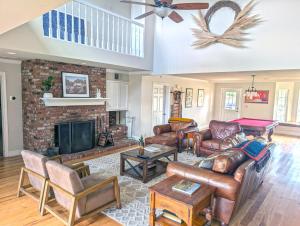 a living room with leather furniture and a fireplace at The Vineyard Farmhouse Villa in Paso Robles