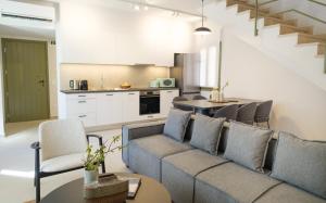 a living room with a couch and a kitchen at Villa Selina 4 - Etheras Properties in Kythira
