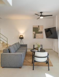 a living room with a couch and a table at Villa Selina 4 - Etheras Properties in Kythira