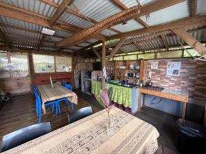 a kitchen with tables and chairs in a room at Hostal Vieroto in Hanga Roa